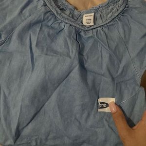 The brand of the shirt is old navy. The color is light blue.Short sleeve.